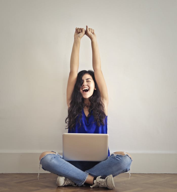 Woman in Blue Denim Jeans Sitting on Floor