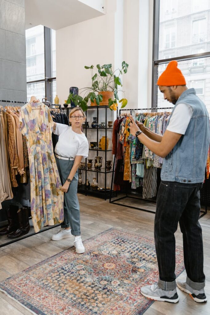 A Man Taking Picture of a Woman Holding a Dress